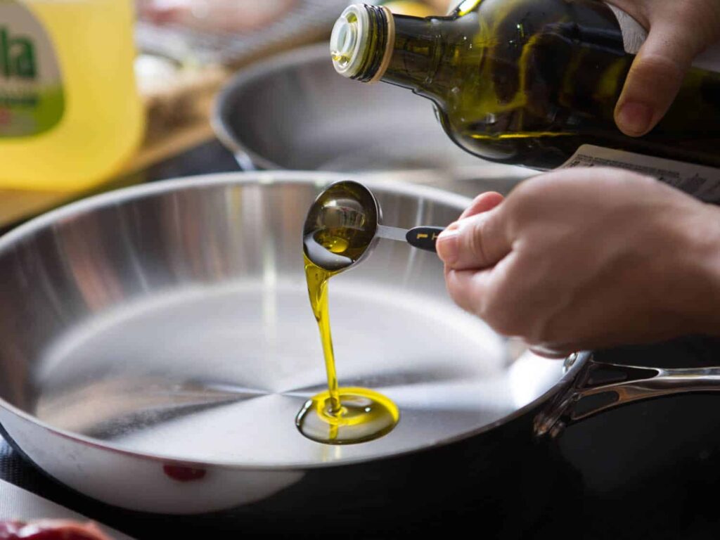 Heat olive oil in a pan. Add garlic and vegetables stirring until tender